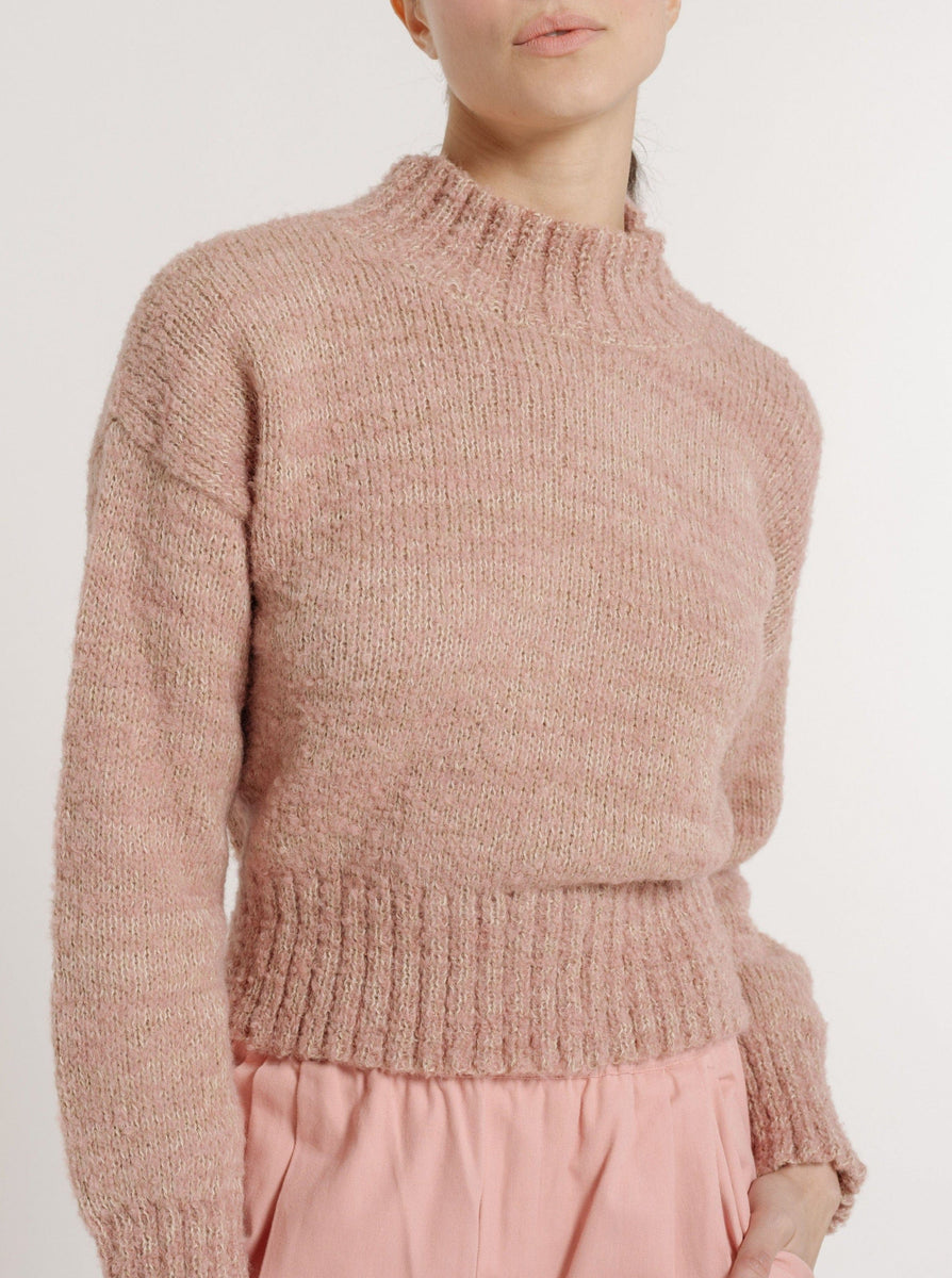 The model is wearing a cozy Claudia Sweater - Pincushion Pink and pink pants.
