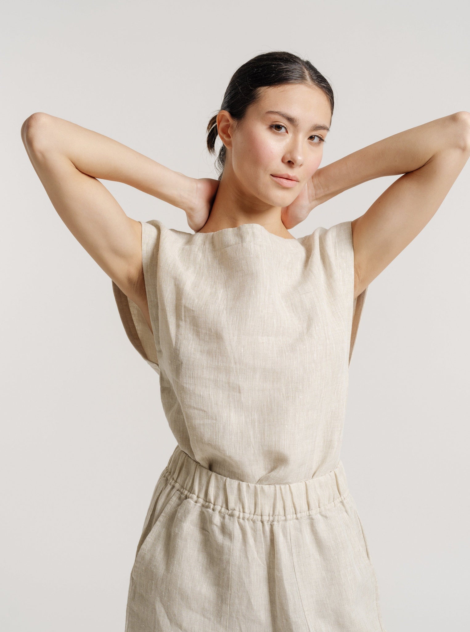 An Everyday Top - Natural Linen made of certified organic linen in beige, paired with shorts.