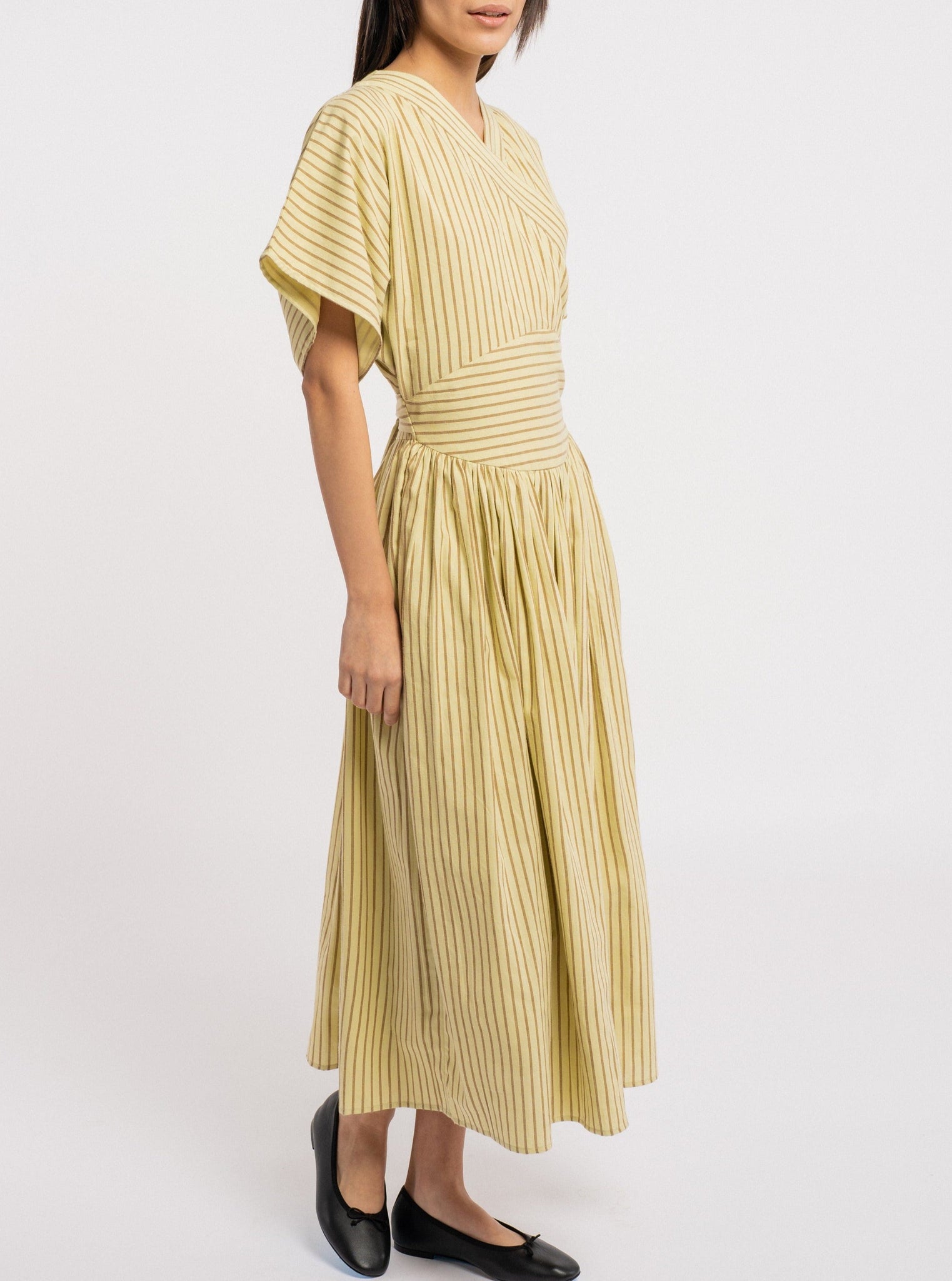 A handmade model wearing an Anita Dress - Feather Grass Stripe.