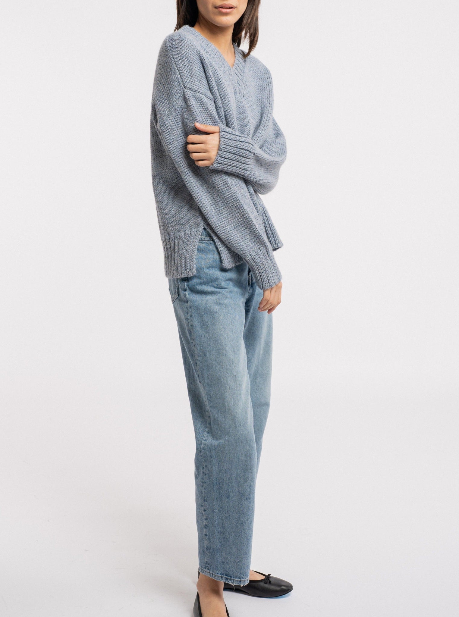 The model is wearing a Billy Sweater - Dusty Blue and jeans.