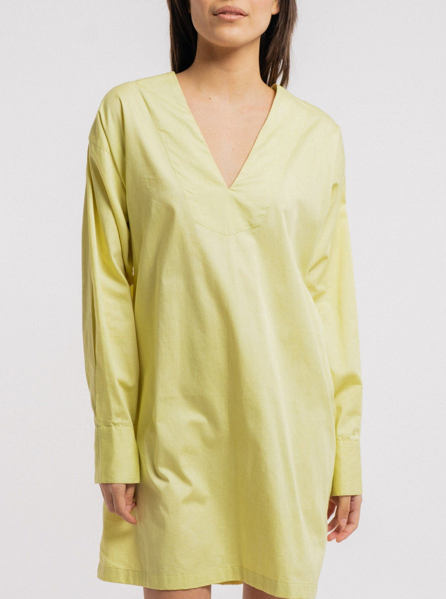 The model is wearing a comfortable yellow Modern Tunic Dress - Celery Green.