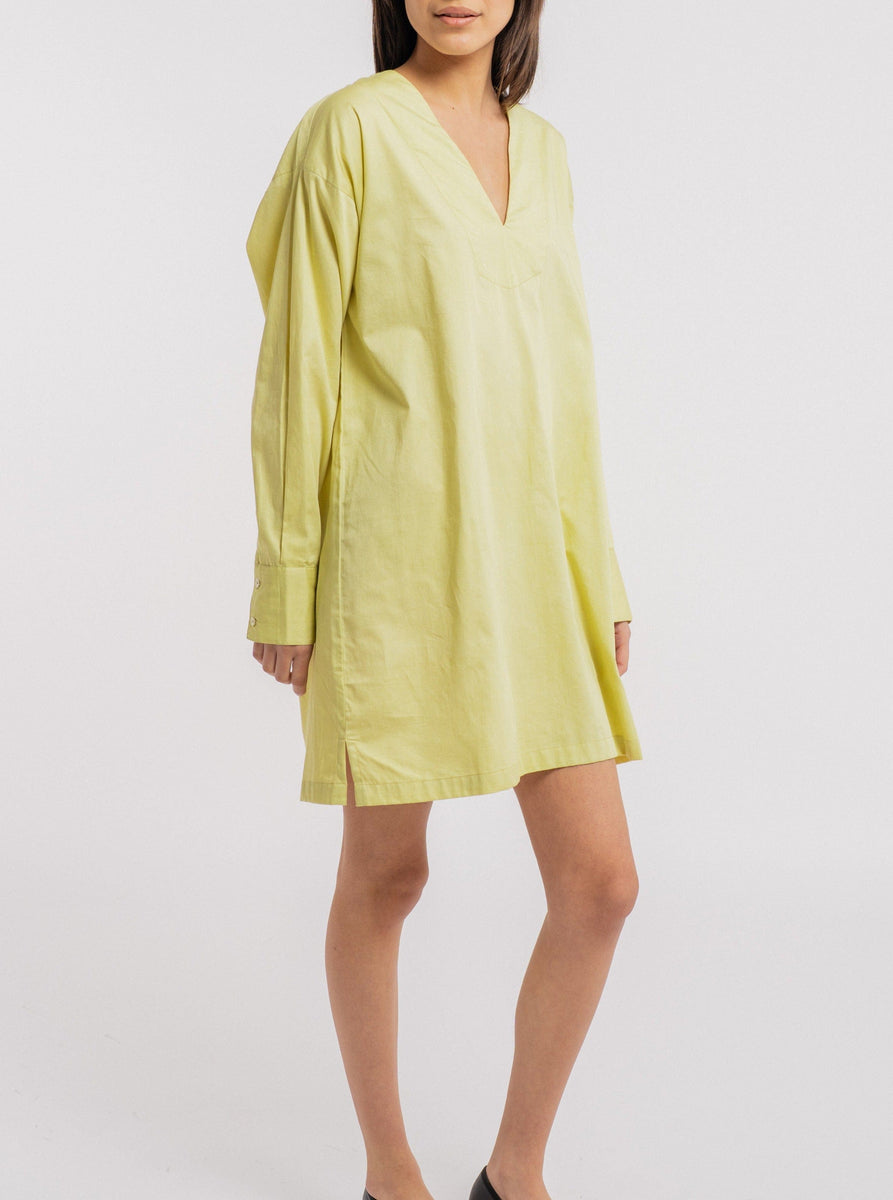 A handmade model wearing a comfortable Modern Tunic Dress - Celery Green made of organic cotton in yellow.