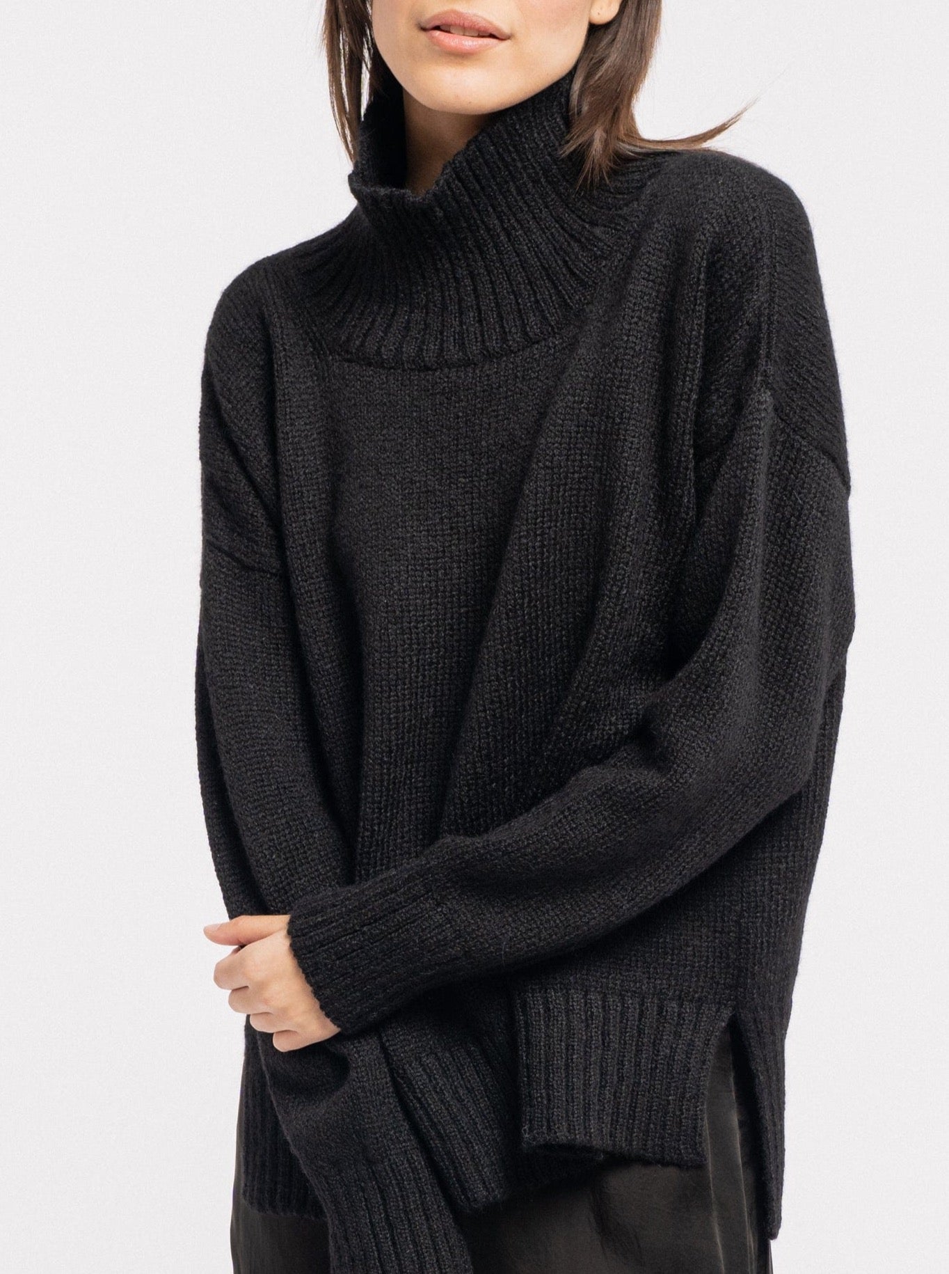 A woman in a Totto Sweater - Black - pre-order.