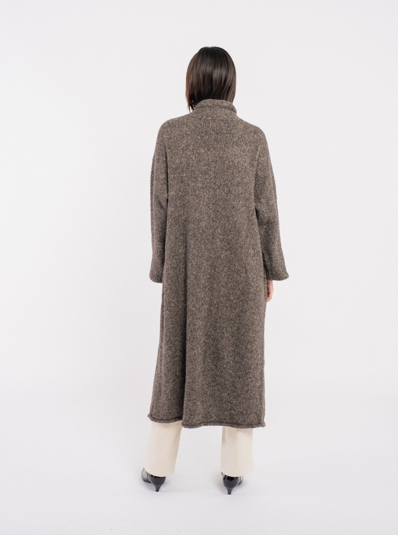The back view of a woman wearing the Heirloom Sweater Coat - Nutty Brown - pre-order.