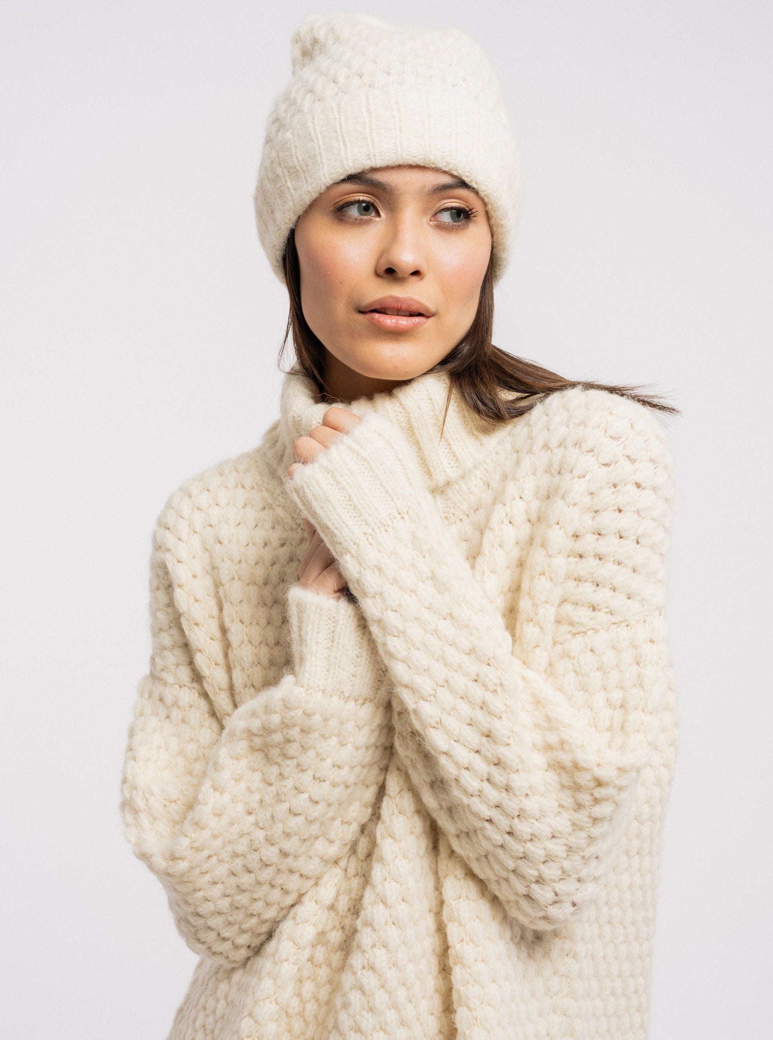 The model is wearing a Heritage Bauble Beanie - Ivory from Peru.
