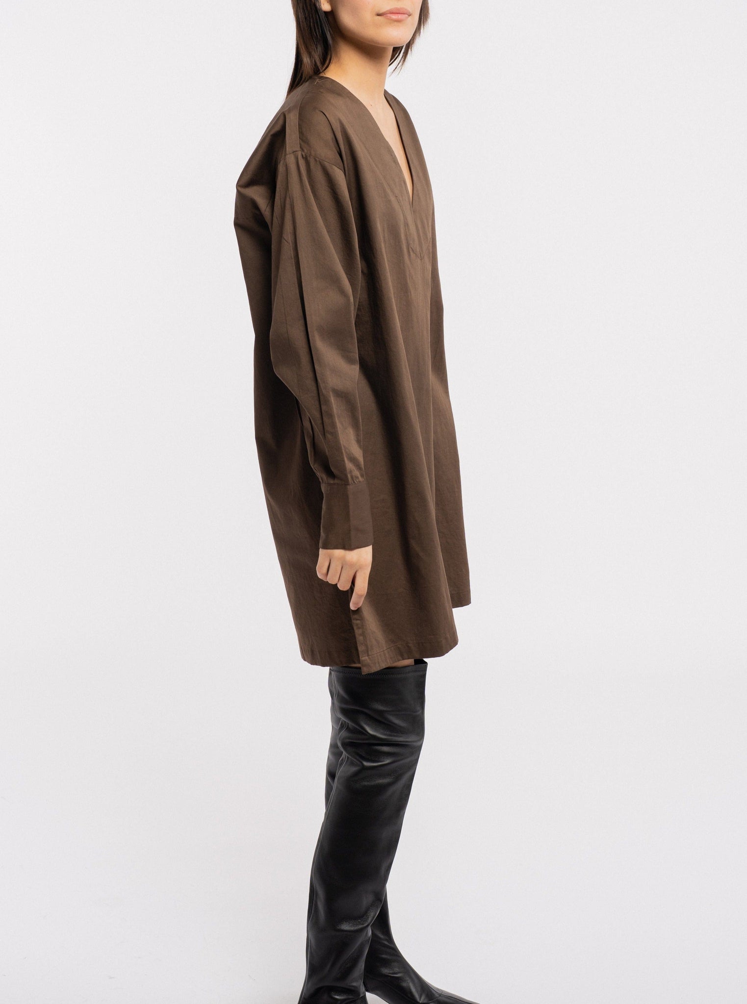 The model is wearing a Modern Tunic Dress - Basalt Brown made of organic cotton, handmade in India.