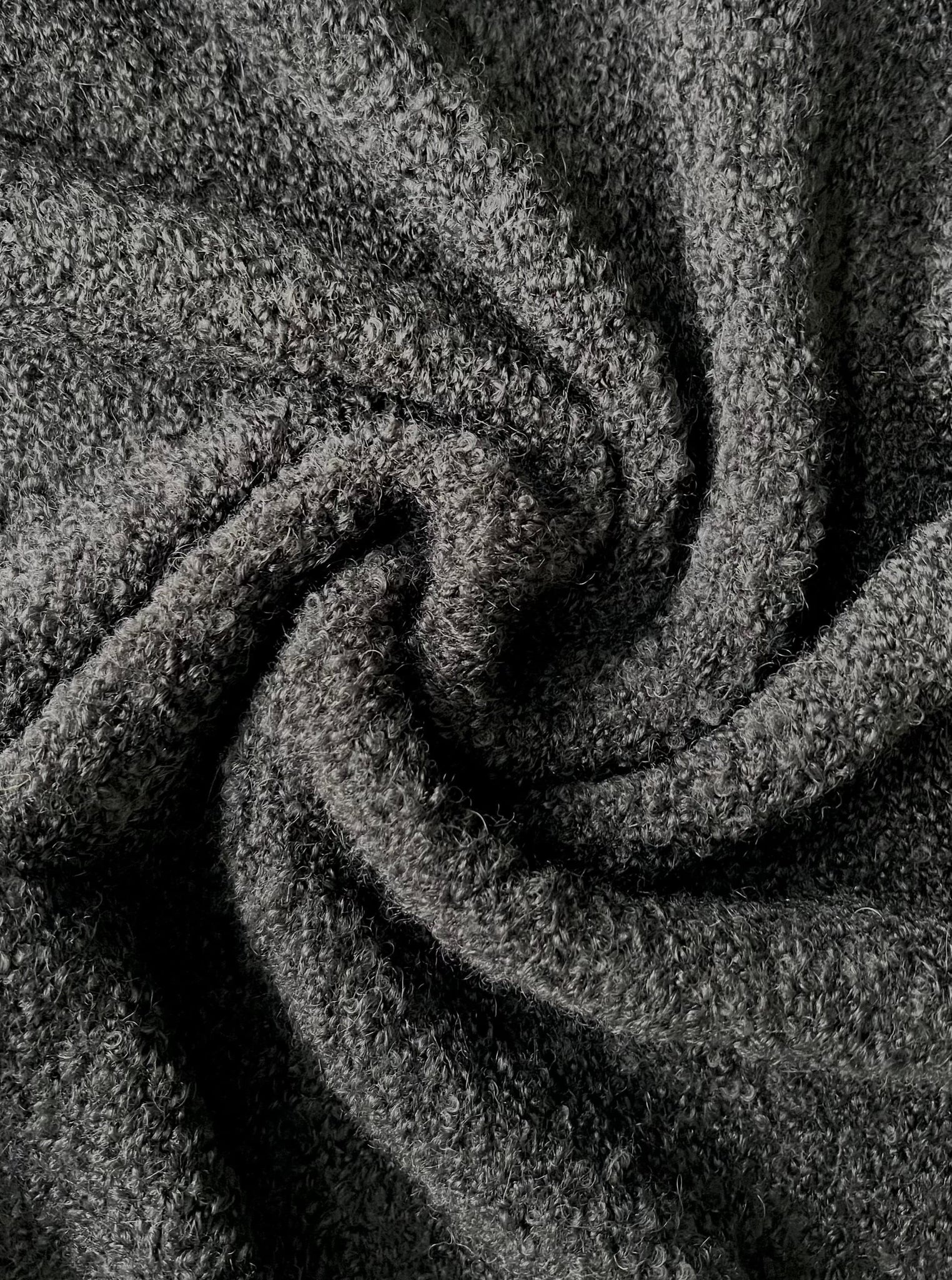 A close up image of a Canyon Wrap Sweater Coat - Charcoal Grey fabric.