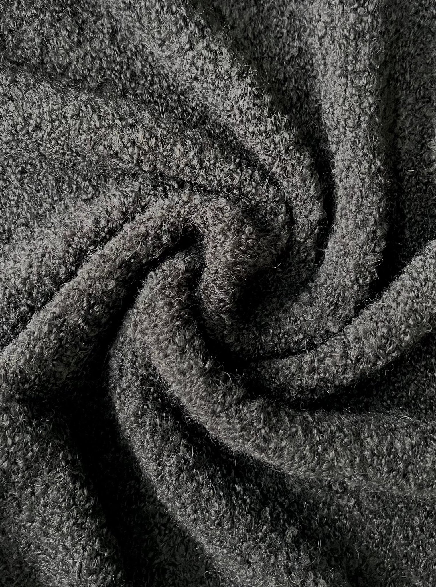 A close up image of a Heirloom Knit Scarf - Charcoal Grey.
