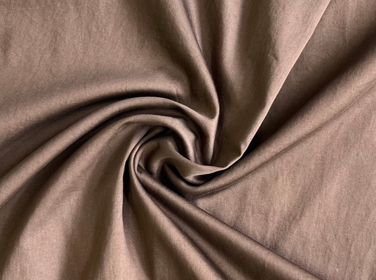 A close up of a Modern Tunic Dress - Basalt Brown, showcasing its organic cotton material.