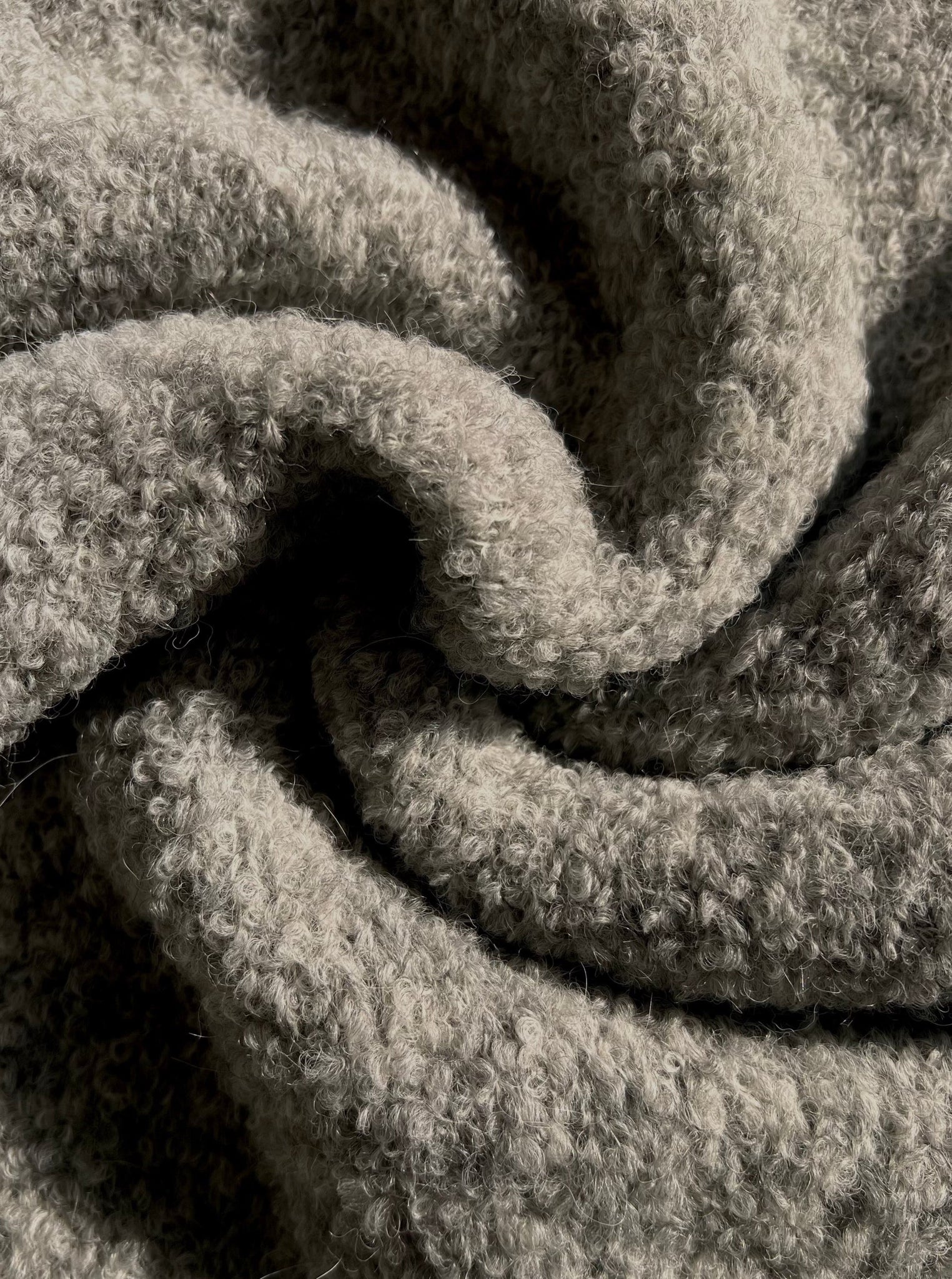 A close up image of a Totto Sweater - Ghost Grey made with alpaca fiber.