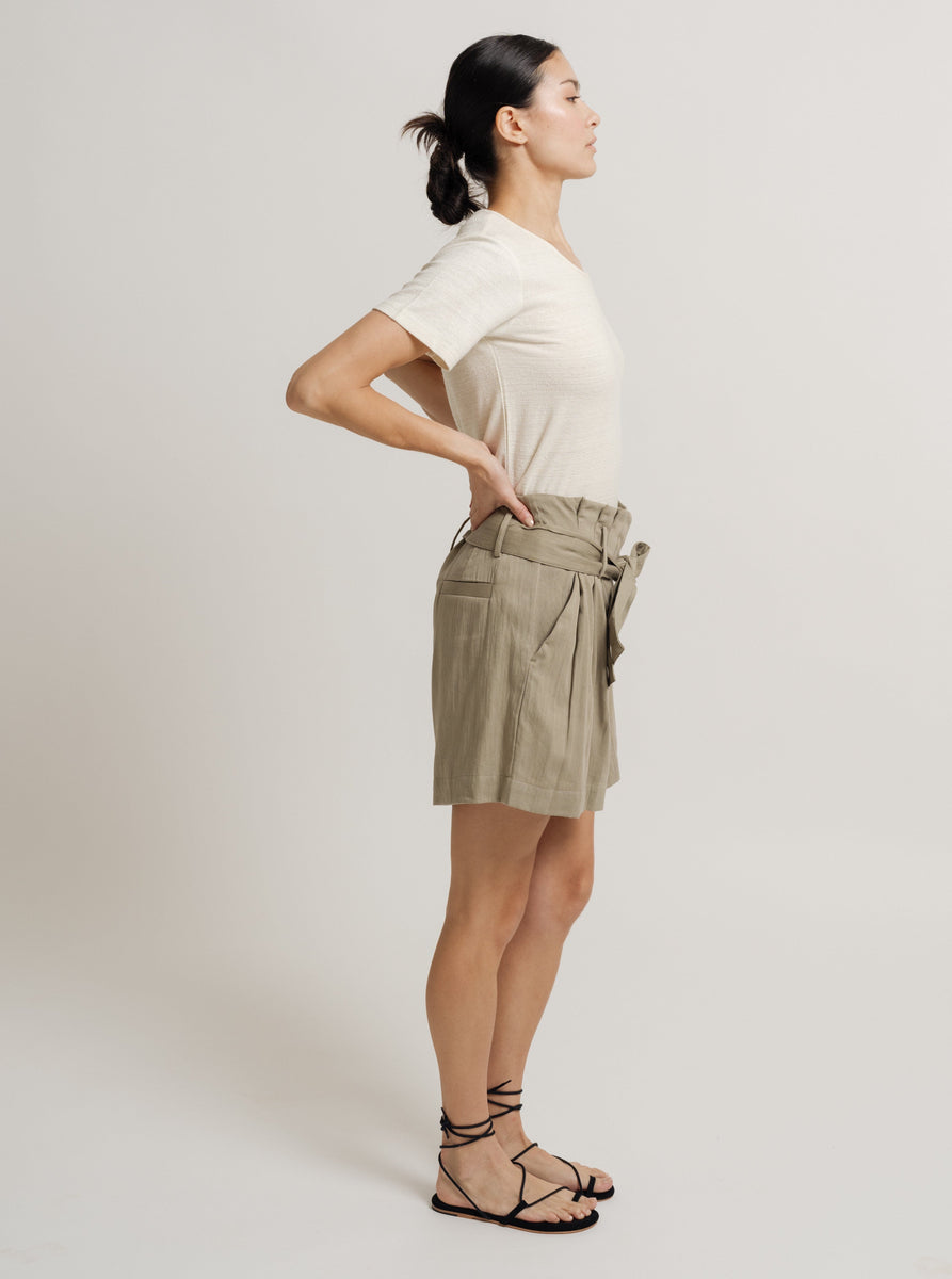 The model is wearing a Paper Bag Short - Putty - Pre-order with a belt.