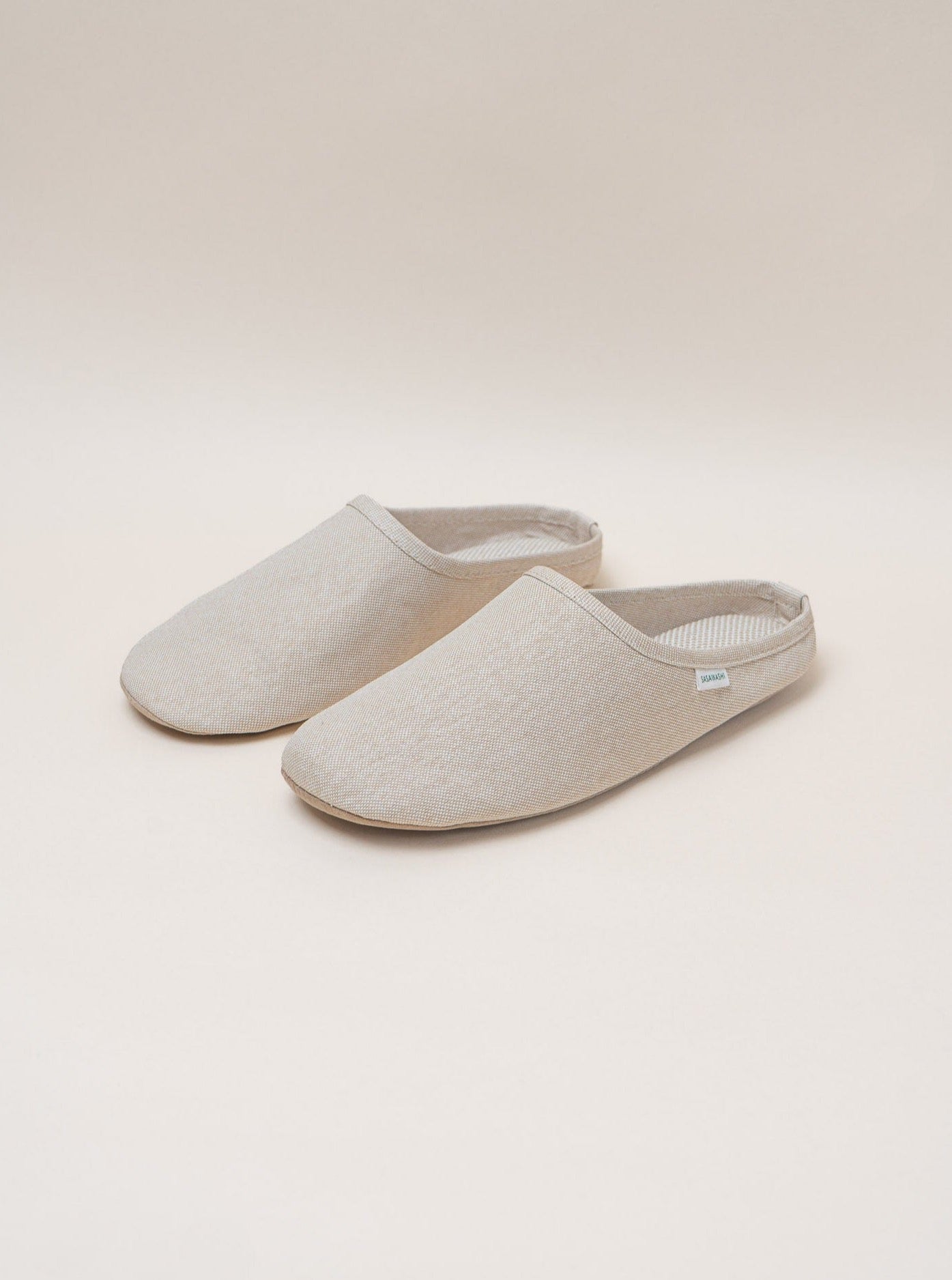 A pair of breathable beige Sasawashi Room Shoes crafted in Sasawashi fabric, on a white background.