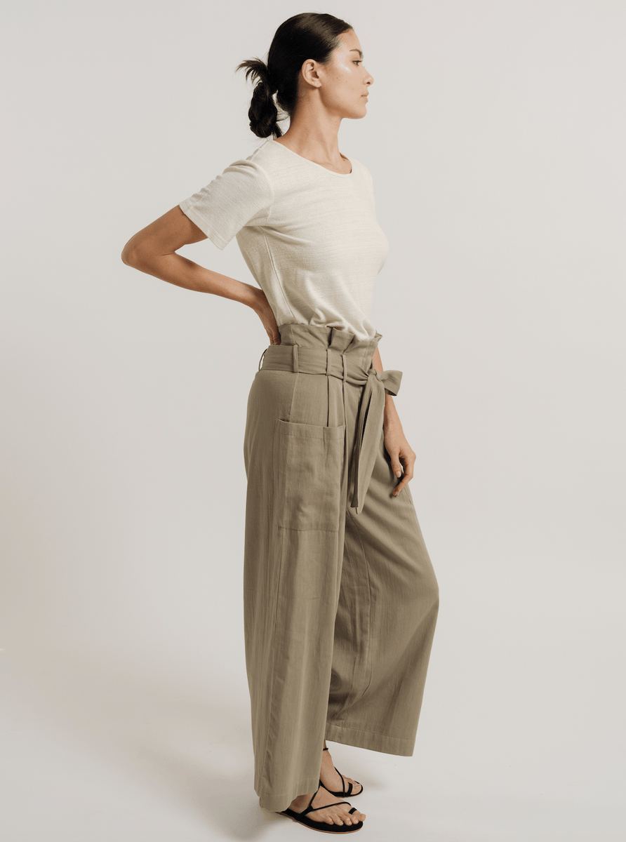The model is wearing a white t-shirt and Paper Bag Pant - Putty - Pre-order in a wide-leg silhouette.