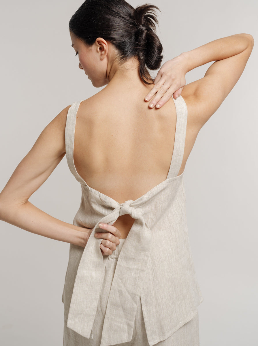 The back of a woman wearing a Tie Back Linen Tank - Natural made from organic linen.