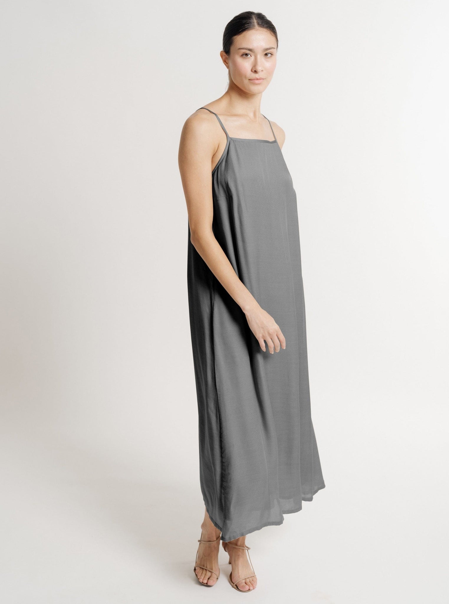 The model is showcasing a like-new Kate Dress - Slate - Sample.