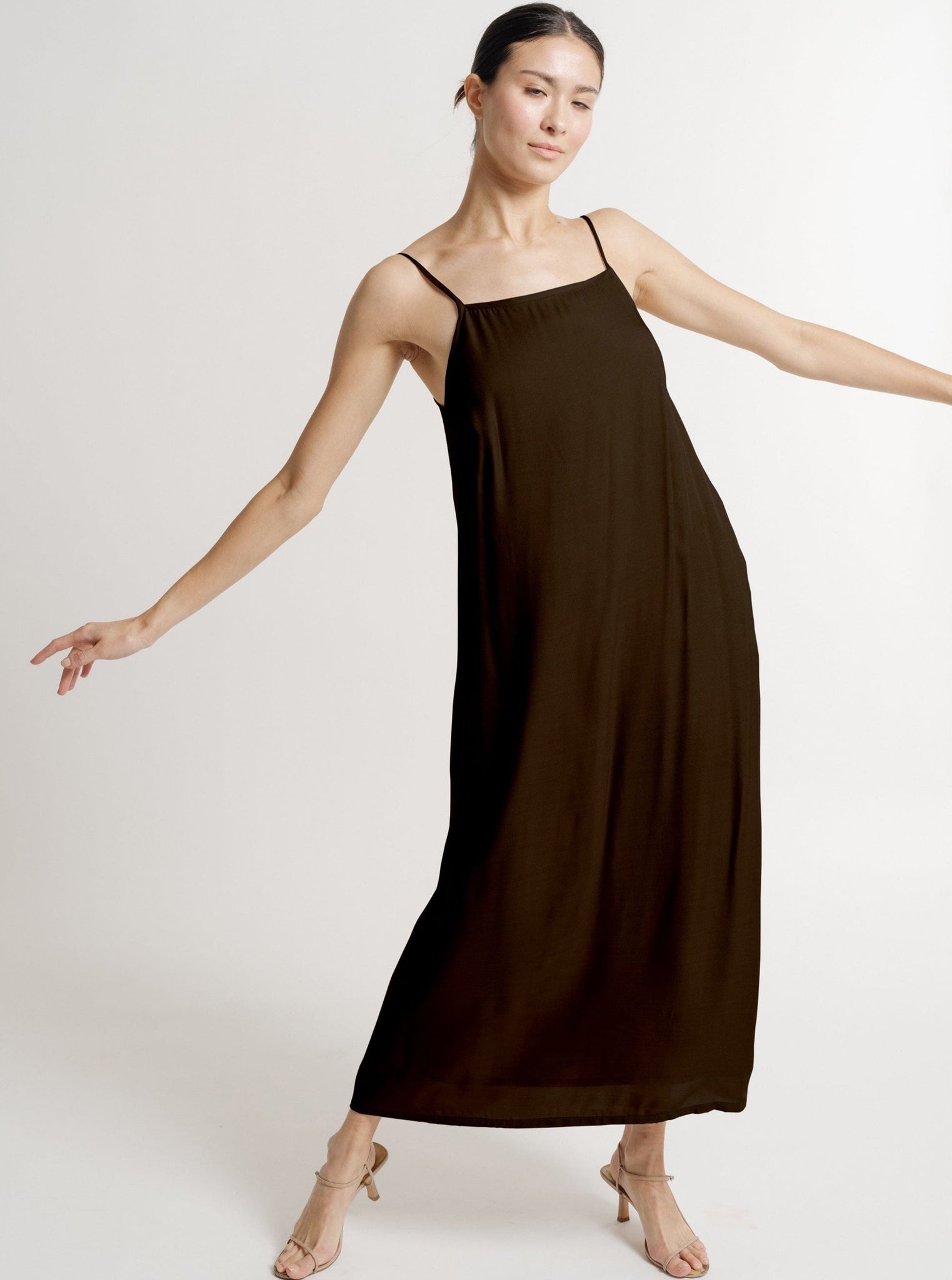 The sustainably made model is wearing a Kate Dress - Basalt Brown.