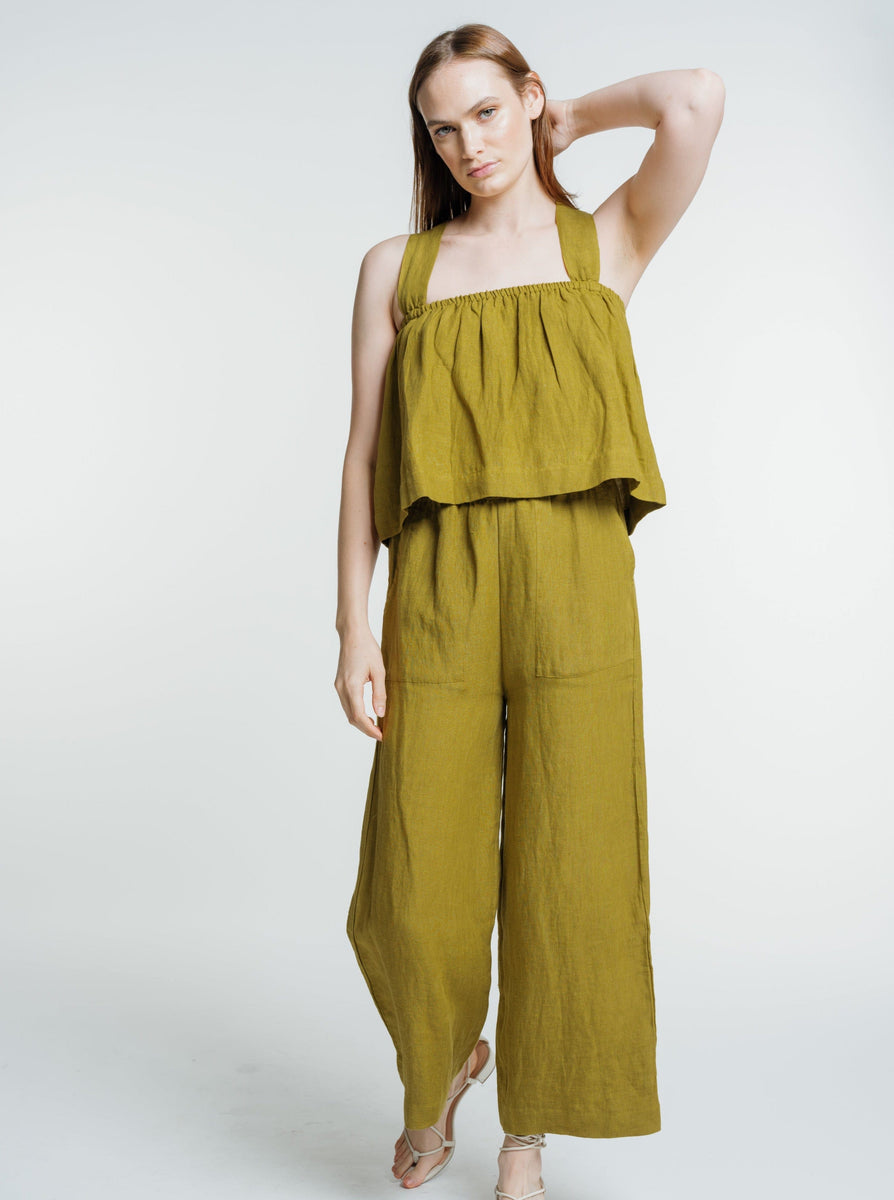 The model is wearing a green Everyday Crop - Dried Tobacco.