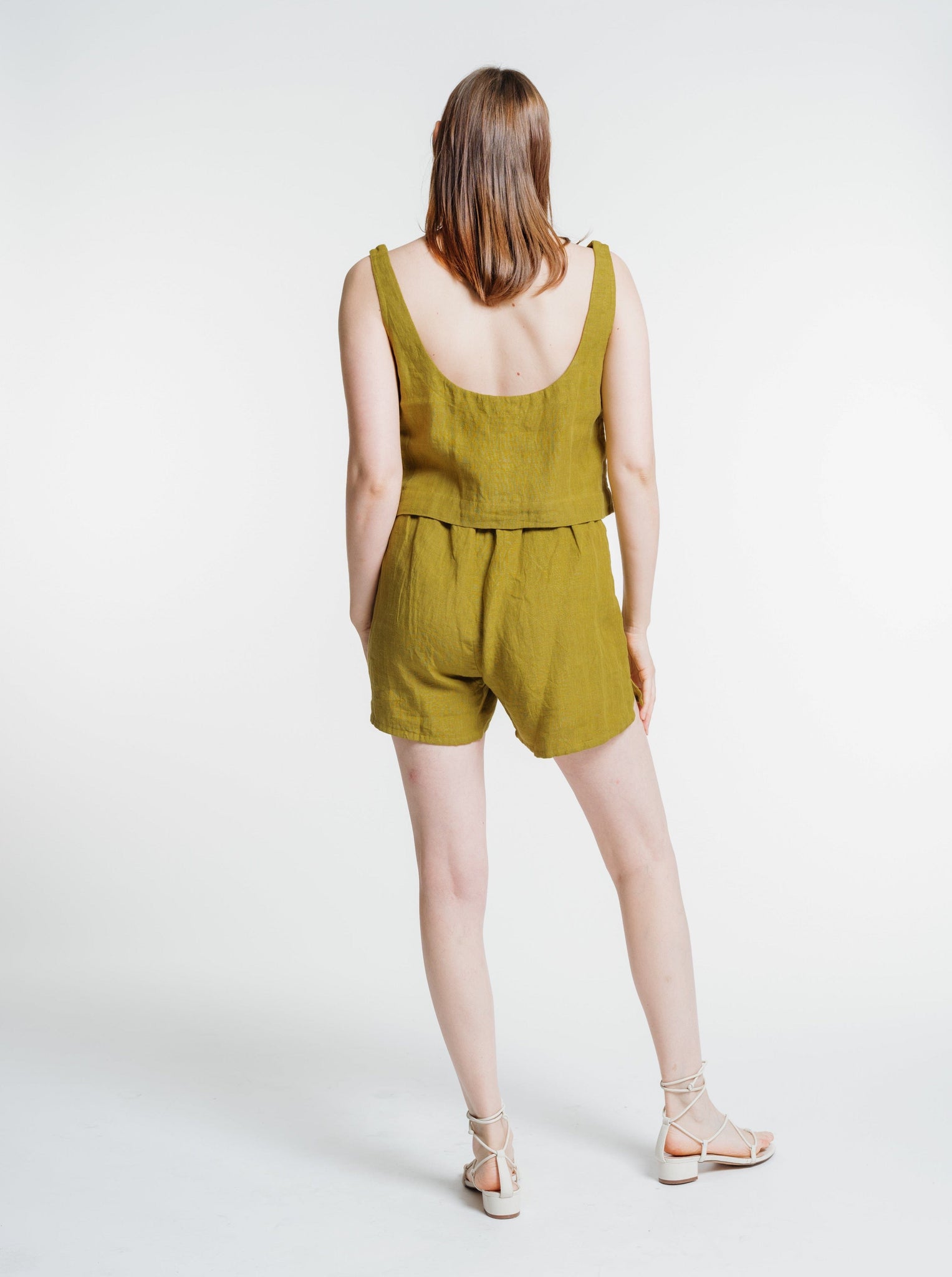 The back view of a woman wearing an Everyday Short - Dried Tobacco.