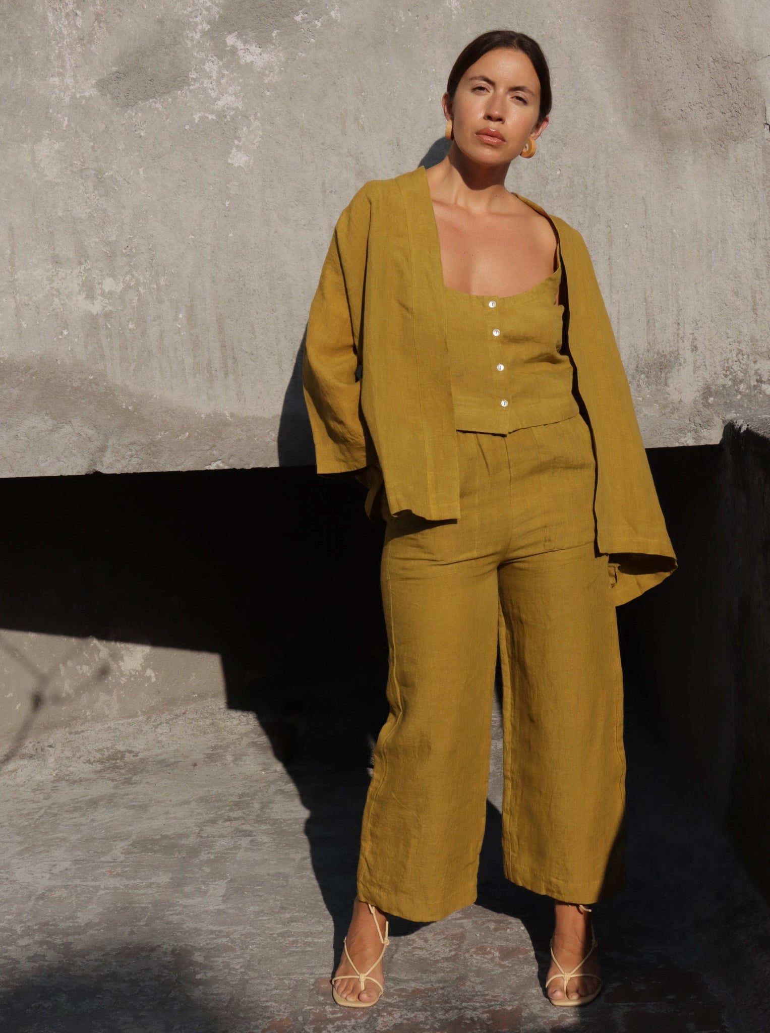A woman wearing the Everyday Crop - Dried Tobacco jumpsuit.