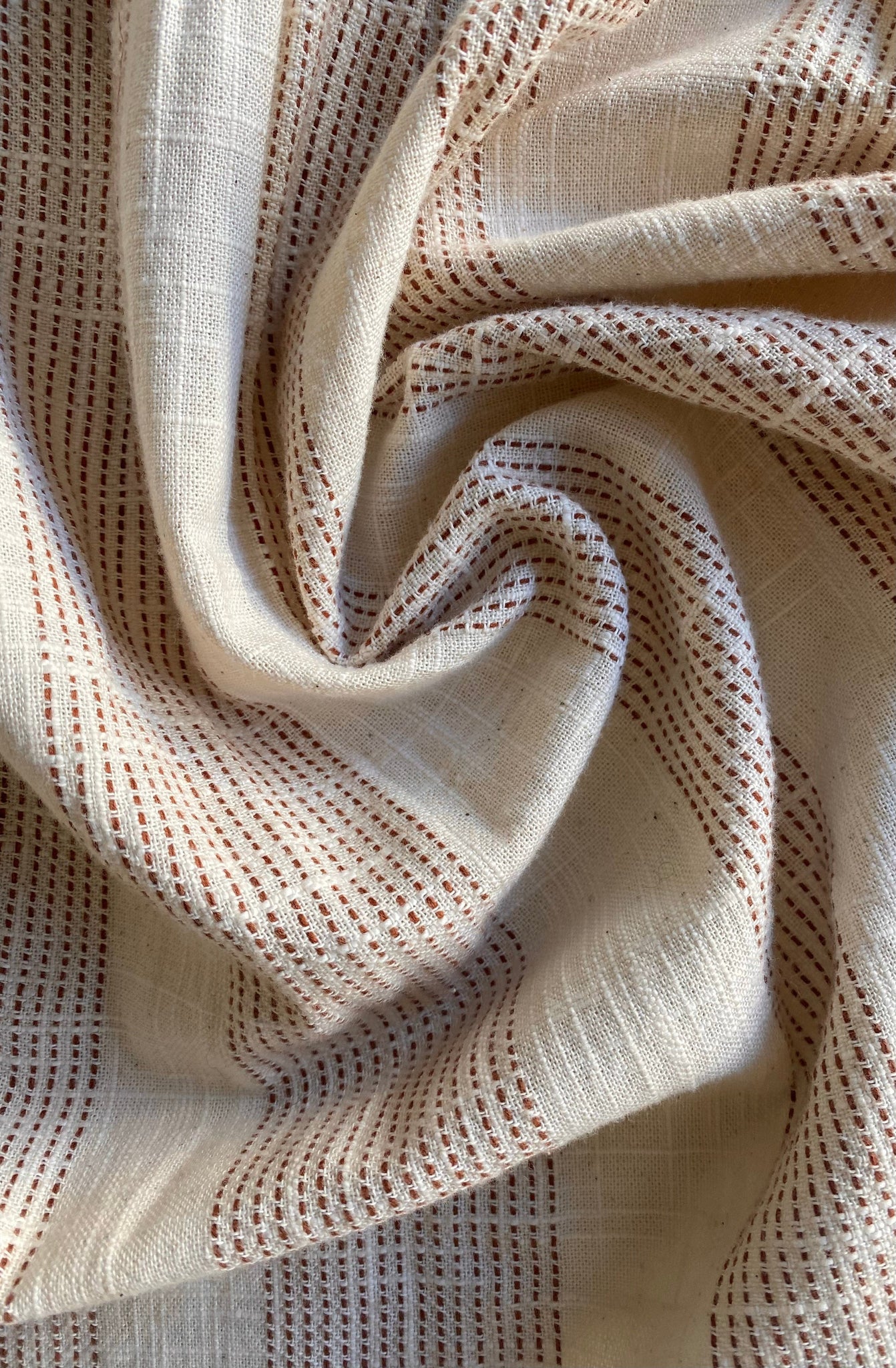 A close up of a beige and brown organic cotton fabric with Baker Top - Terracotta Ticking Stripe - Sample.