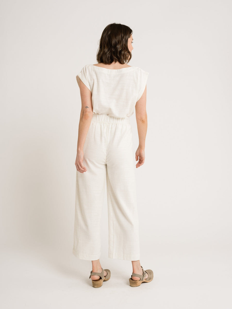 The back view of a woman wearing Everyday Crop Pant - Ivory.