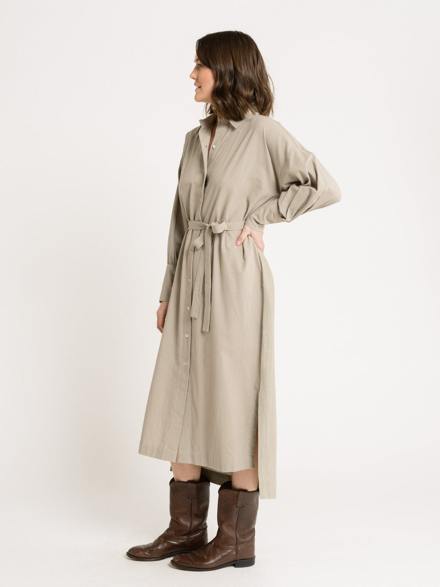 The model is wearing a Dillon Dress - Mushroom - XXL - Sample made from organic cotton and paired with cowboy boots.
