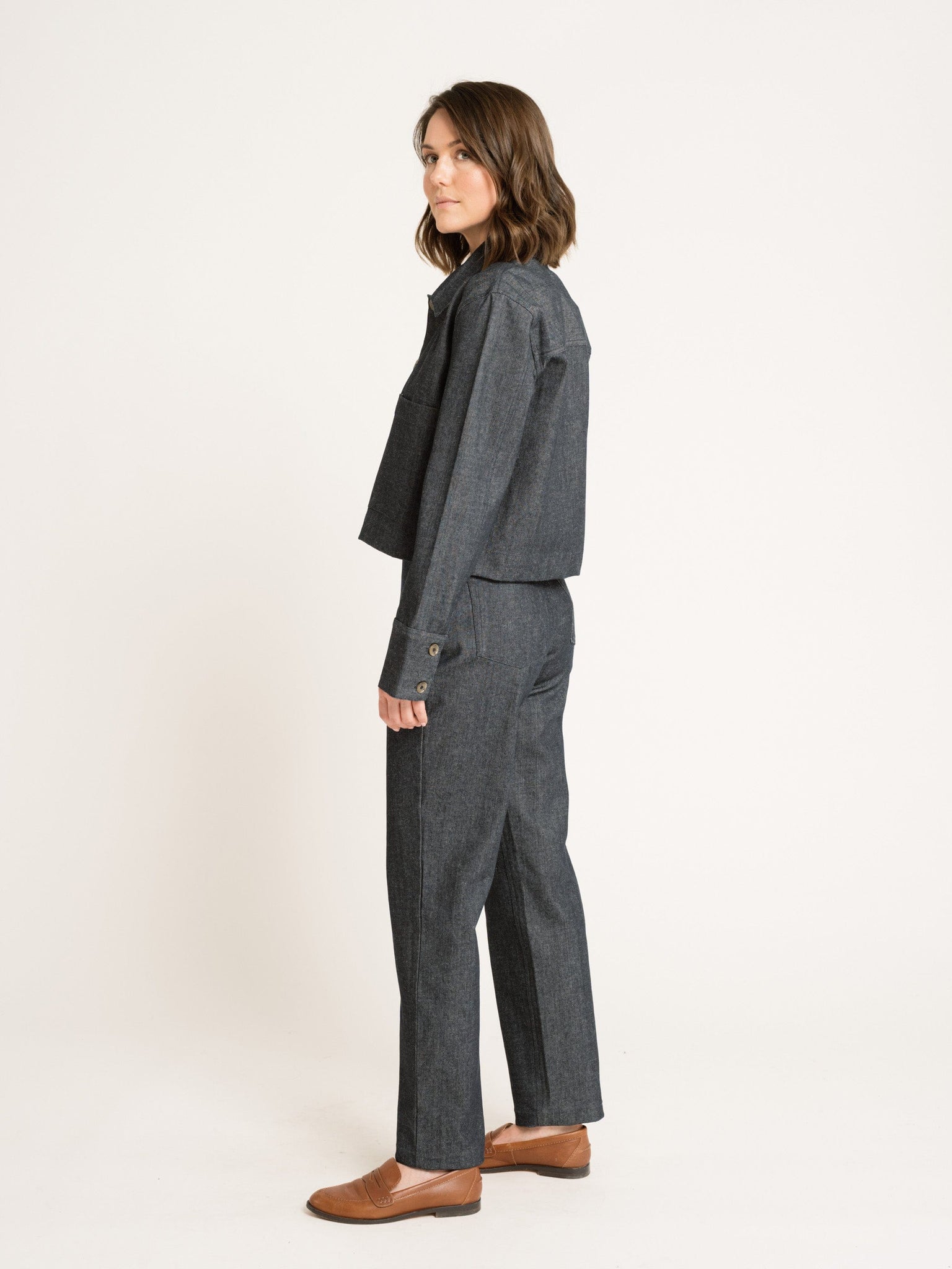 The back view of a woman wearing a Camp Jacket - Vintage Denim jumpsuit.
