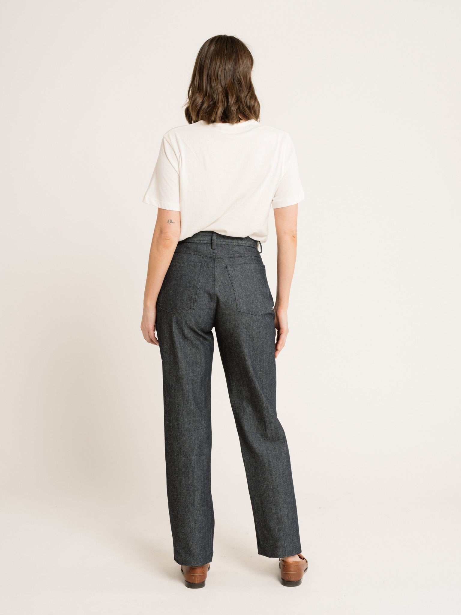 The woman is wearing a pair of Camp Pants - Vintage Denim - Samples made from organic cotton, perfect for machine wash.