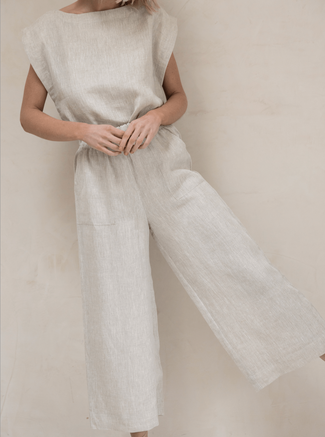 A woman wearing a white Everyday Pant - Natural Linen jumpsuit.
