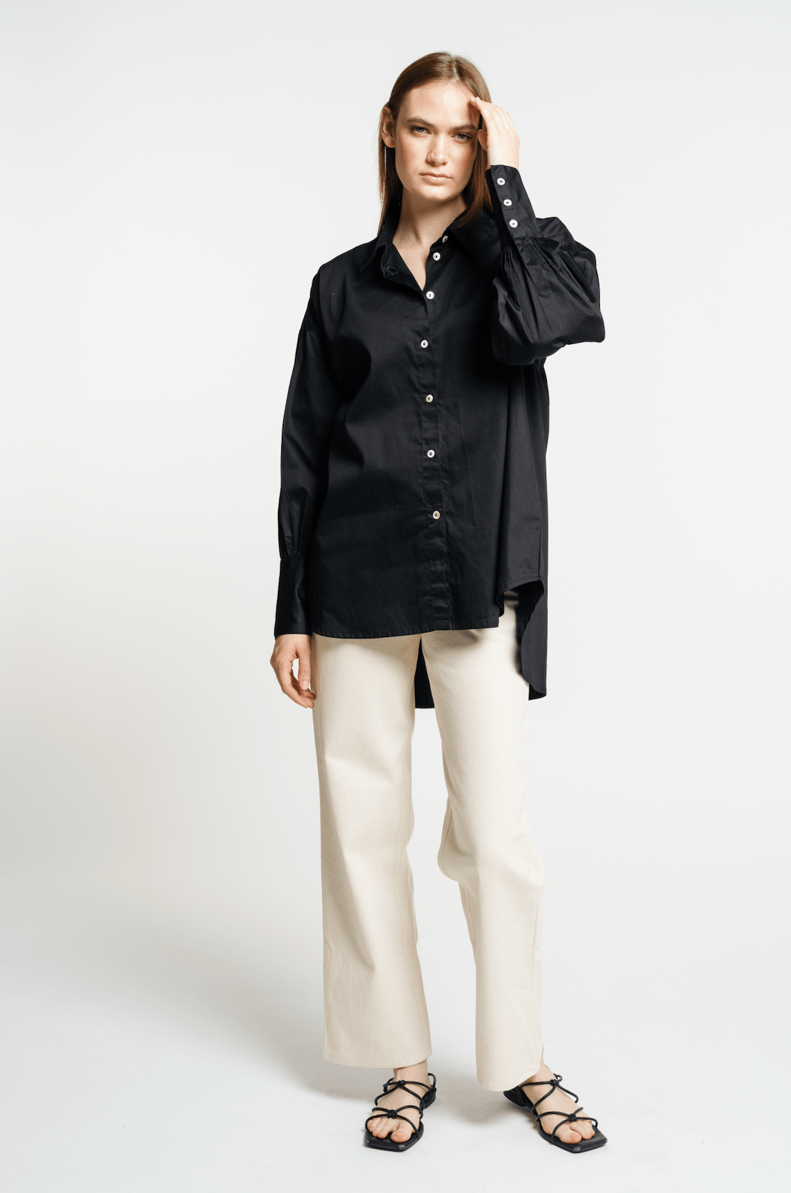 The model is wearing a Museo Button Up - Black shirt and beige pants.