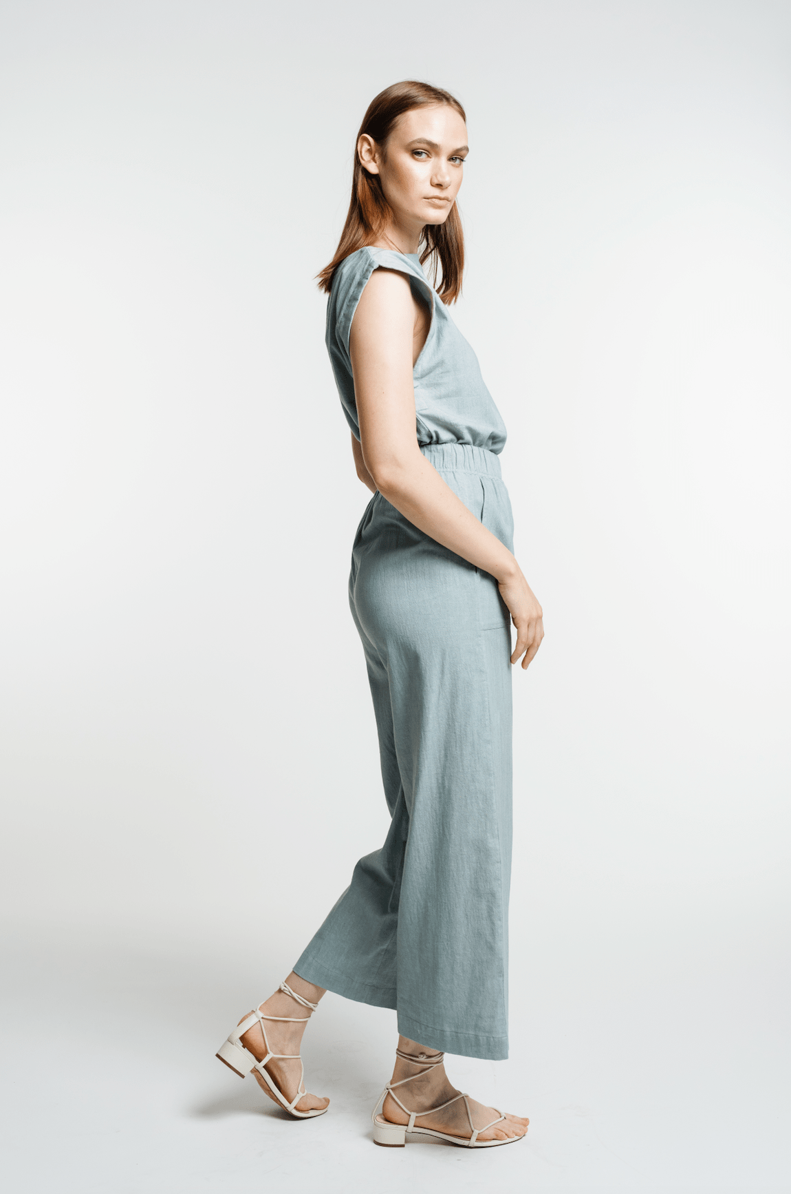 A woman in the Everyday Crop Pant - Cielo standing on a white background.