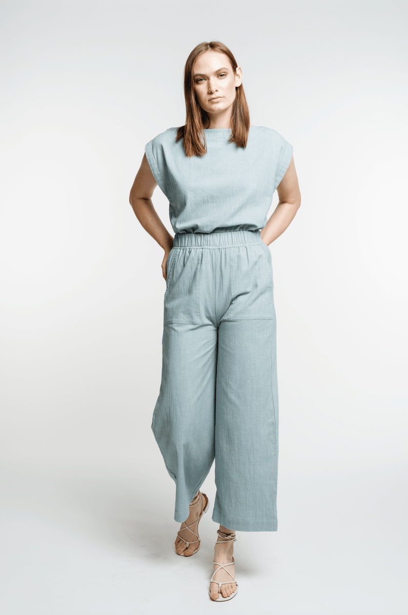 The model is wearing the Everyday Crop Pant - Cielo.