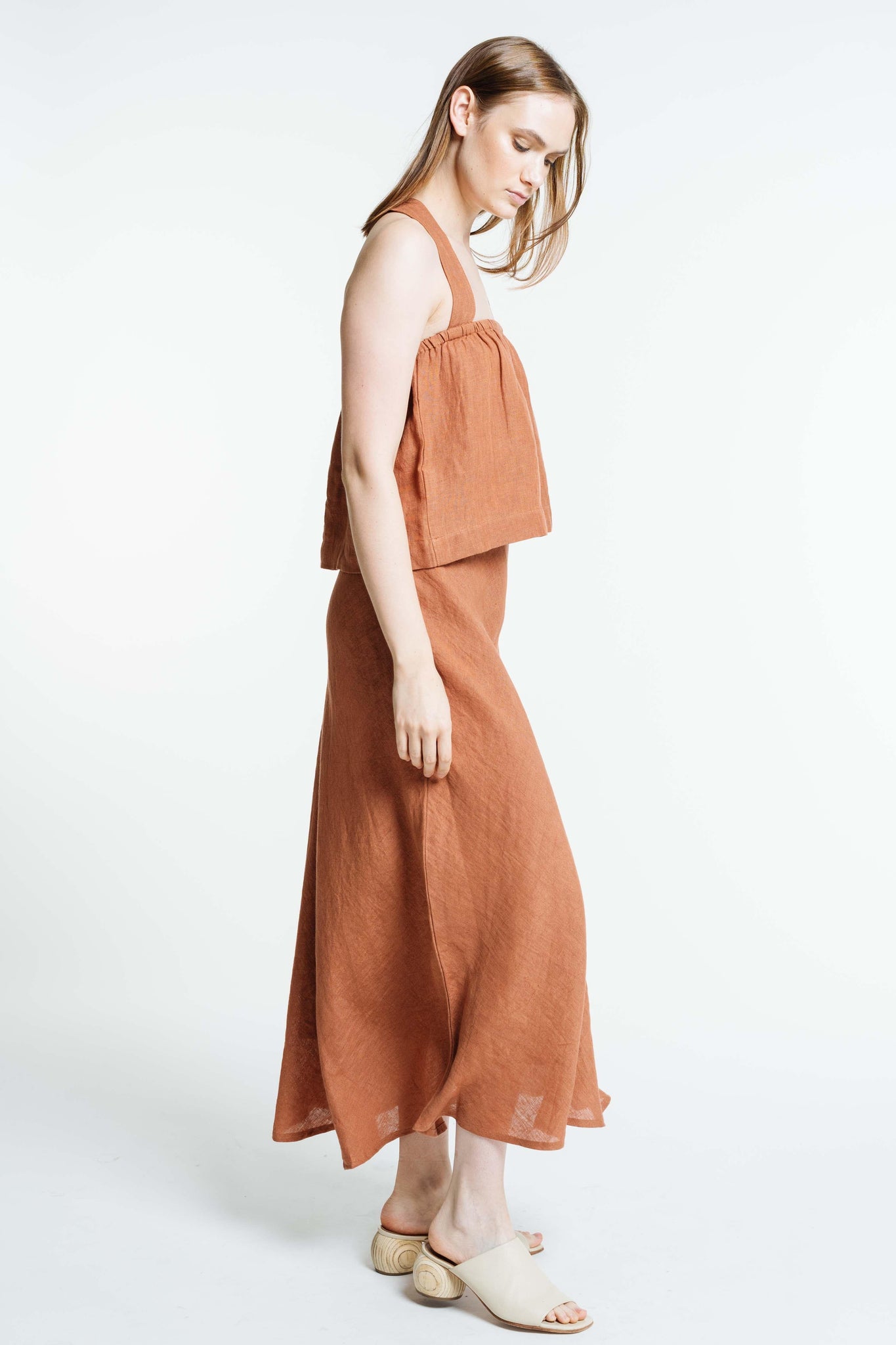 The model is wearing a Breeze Tank - Amber Brown - Sample linen dress.