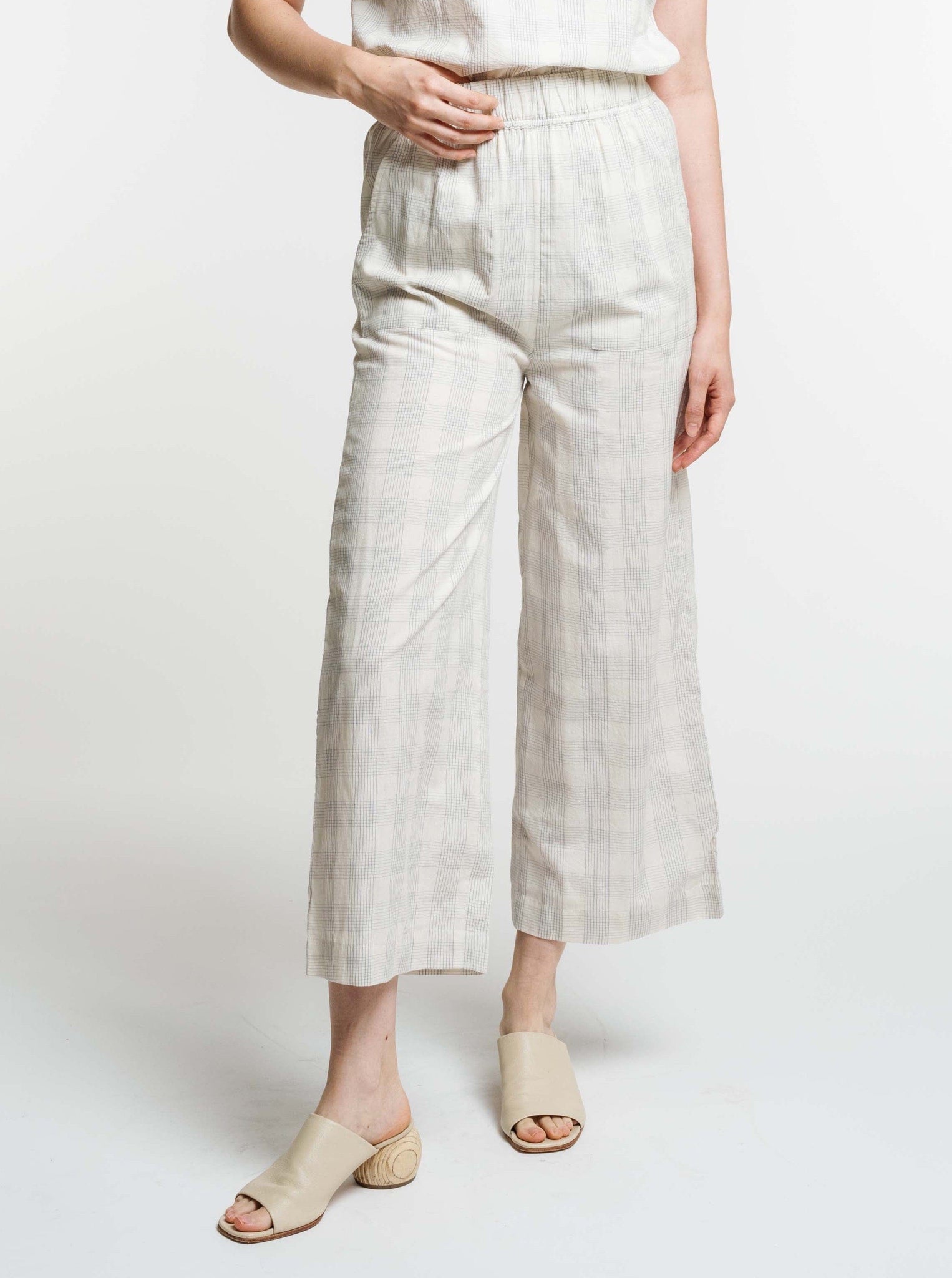 A woman wearing the Everyday Crop Pant - Rivera Plaid.