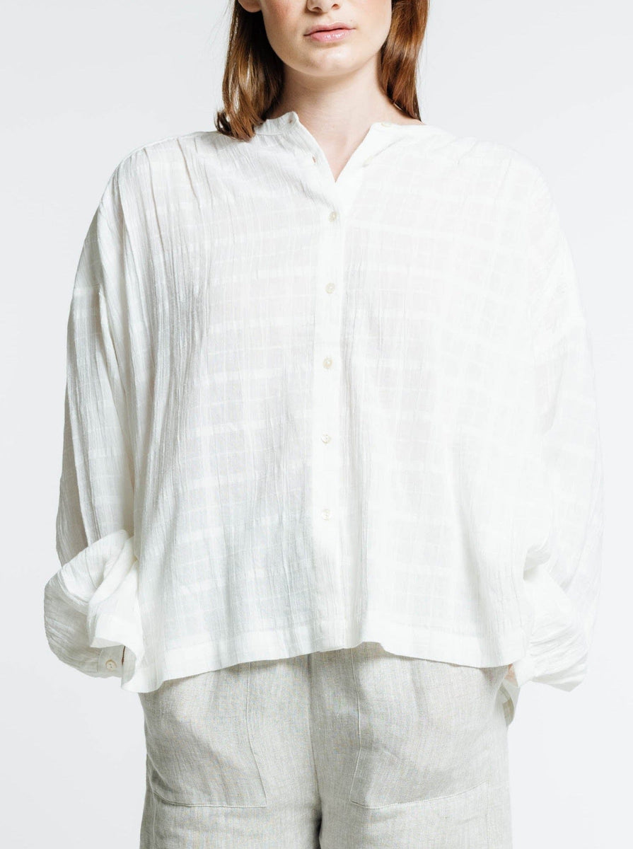 The model is wearing the Francoise Top - Alabaster Plaid and linen pants.