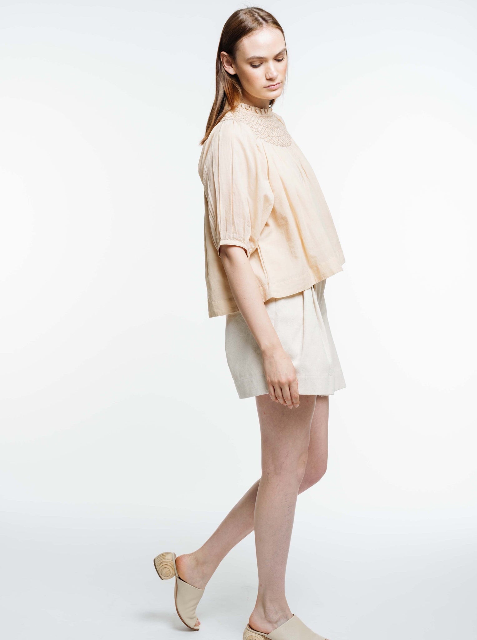 The model is wearing an organic cotton Lena Top - Acacia Wood.