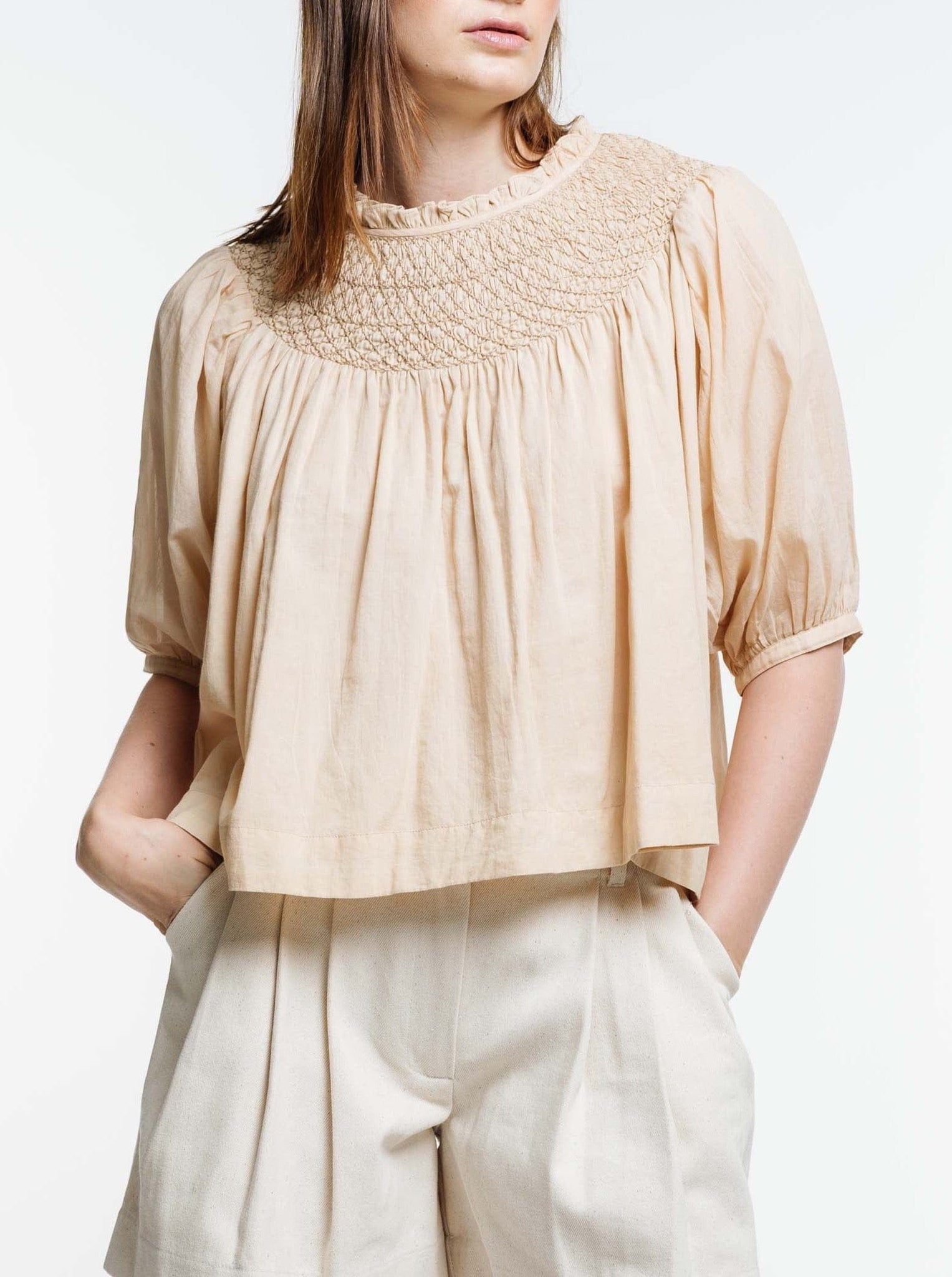 The model is wearing an Organic Cotton Lena Top.