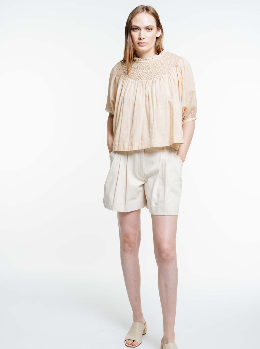 The model is wearing an organic cotton Lena Top - Acacia Wood.